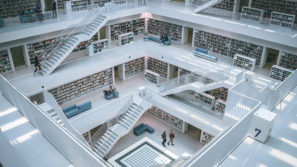A large library with many shelves and stairs