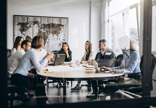 Some people gathered around a round table discussing business related topics